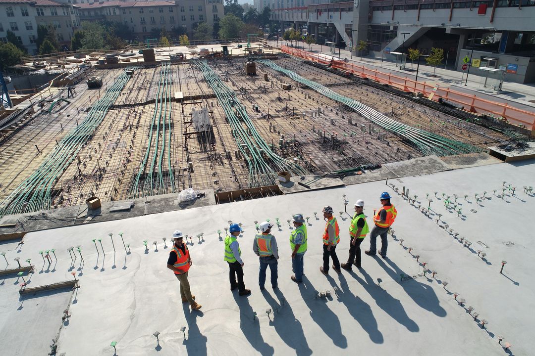Crew in safety vests on a large commercial work site